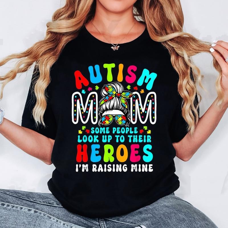 [100% Cotton] Autism Mom Raising Hero Groovy Messy Bun Autism Awareness T-Shirt Hoodie, Sweatshirt | TeeBloomCo.com