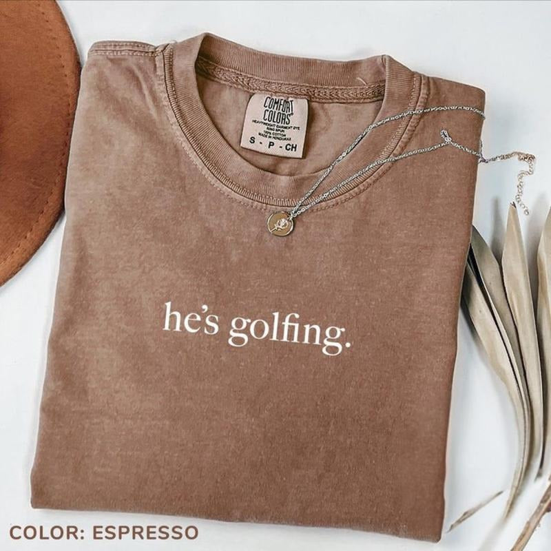 Comfort Colors He's Golfing Shirt, Golfing Season Shirt, Golfer Wife Shirt, Golf Player Tee for Mom, Golf Lover Shirt,...