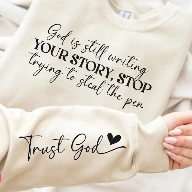 God Is Still Writing Your Story Sweatshirt - Front & Hand, Funny Christian Shirt, Faith Shirt Hoodie | TeeBloomCo.com