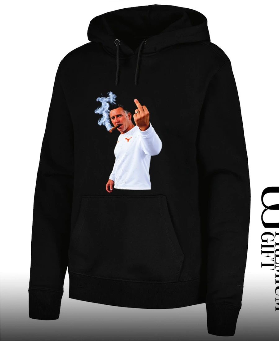 Texas Longhorns head coach Steve Sarkisian smoking a cigar and giving a middle finger shirt