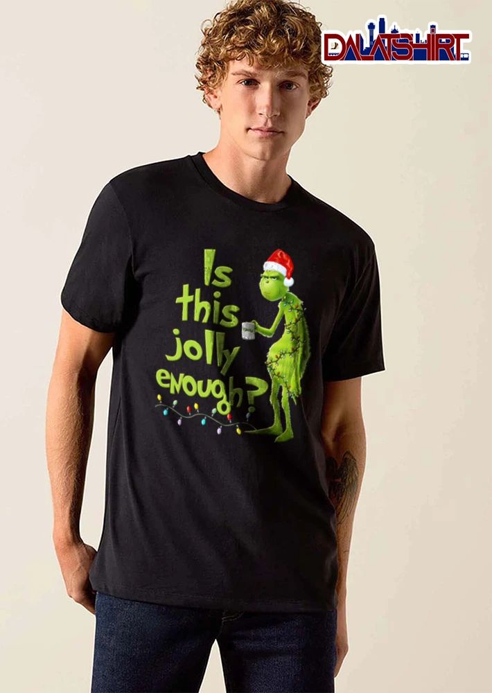 Is This Jolly Enough green furry creature Santa hat holding mug wrapped in Christmas lights shirt