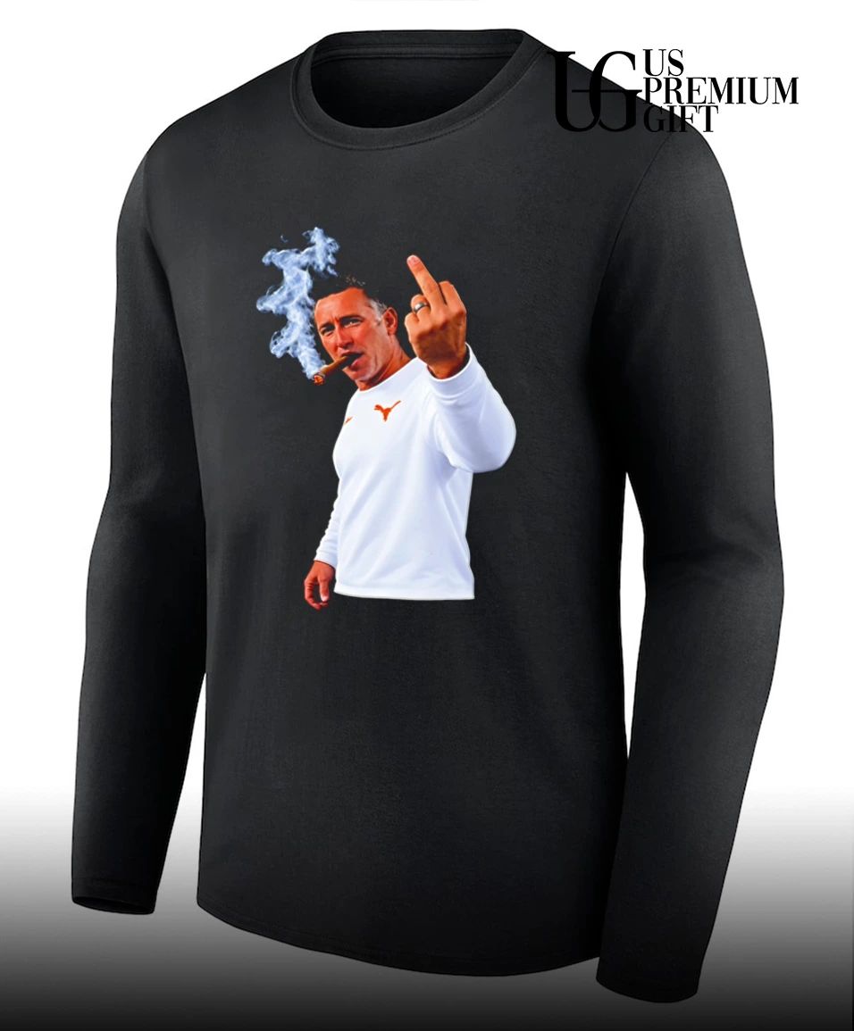Texas Longhorns head coach Steve Sarkisian smoking a cigar and giving a middle finger shirt