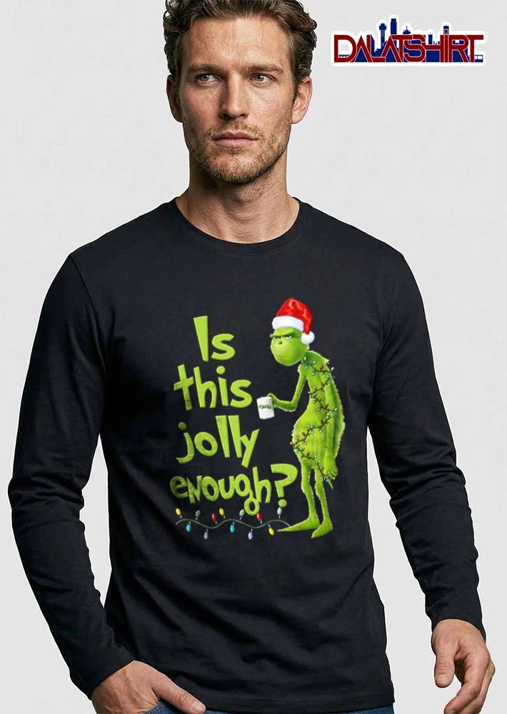 Is This Jolly Enough green furry creature Santa hat holding mug wrapped in Christmas lights shirt
