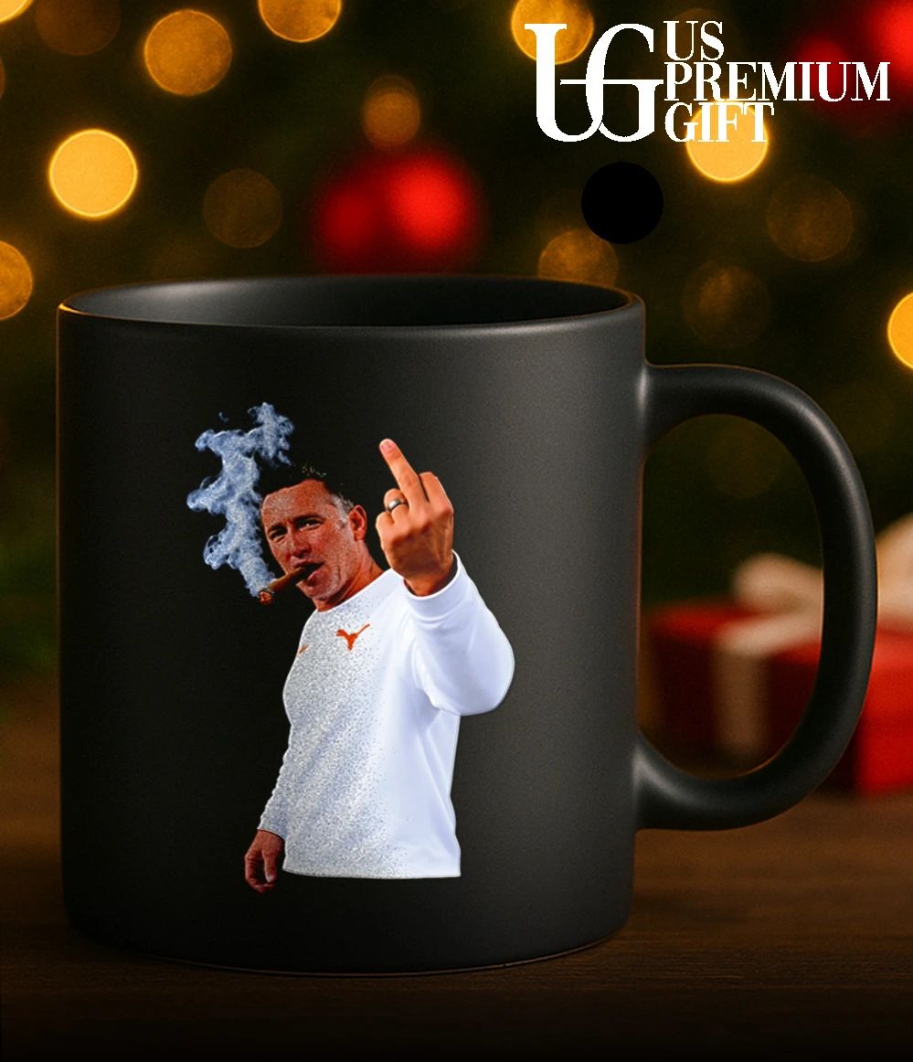 Texas Longhorns head coach Steve Sarkisian smoking a cigar and giving a middle finger shirt