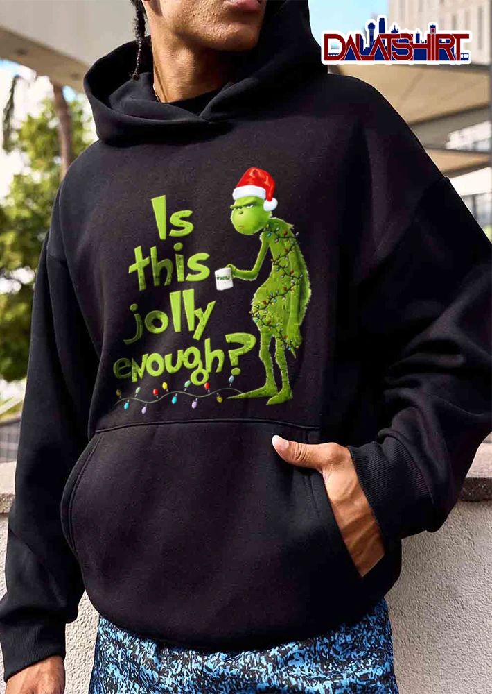 Is This Jolly Enough green furry creature Santa hat holding mug wrapped in Christmas lights shirt